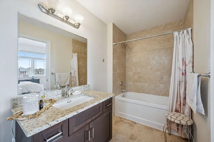 Second bedroom ensuite with soaker tub and granite vanity