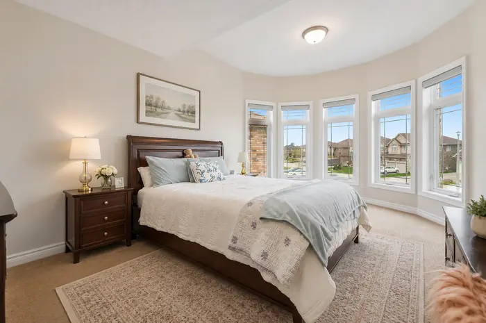 Bedroom with curved bay window, virtually staged