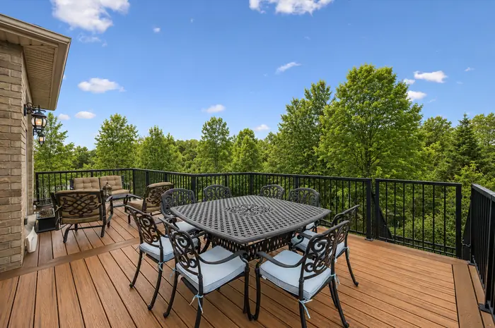 Composite upper deck with outdoor dining overlooking protected greenspace, digitally enhanced image