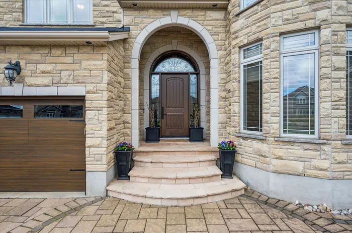 Grand stone entrance of 51 Cox Court with arched doorway and flagstone steps
