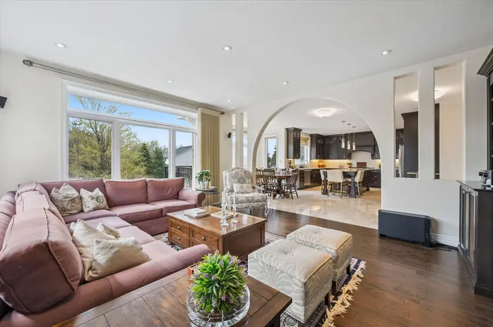 Open-concept family gathering area flowing into the kitchen through an archway