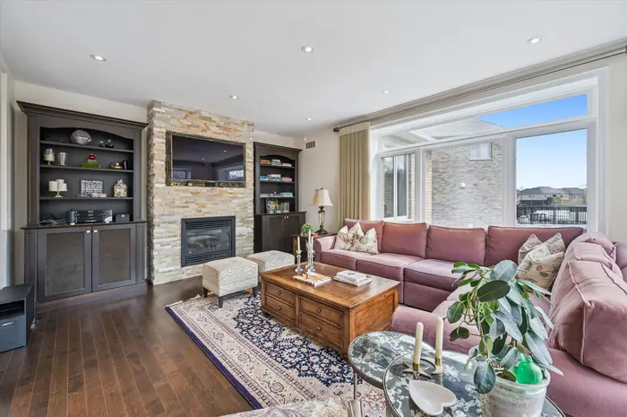 Family room with stacked-stone gas fireplace and custom built-ins