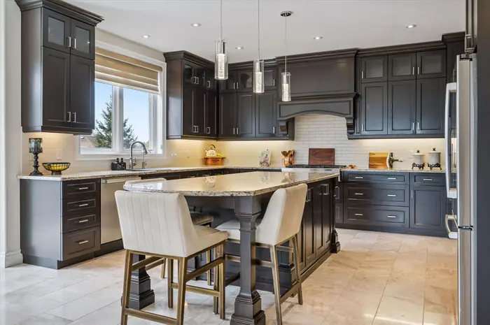 Barzotti-designed kitchen with large granite island and pendant lighting