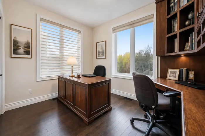 Main-floor office with built-in desk and shelving, virtually staged