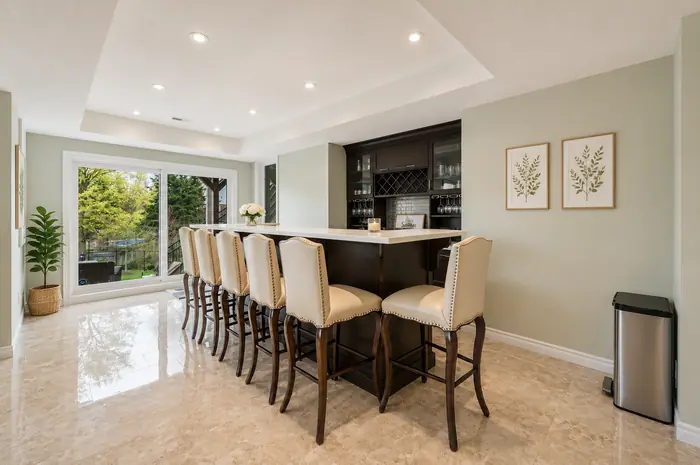 Custom bar with quartz counter, wine storage and seating for six, virtually staged