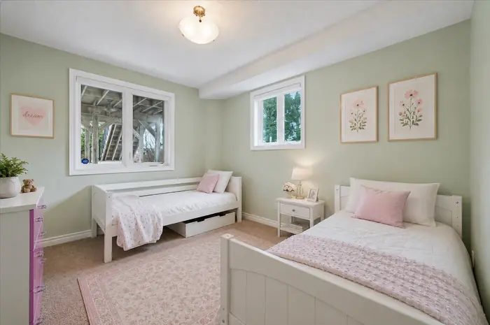 Additional bedroom on the walkout level with two twin beds, virtually staged
